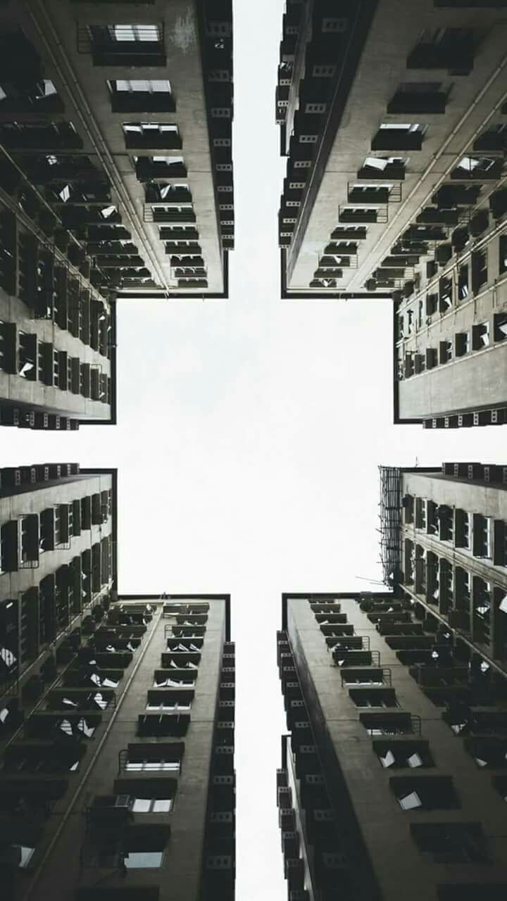 Four towers seen from the courtyard between them, looking straight up